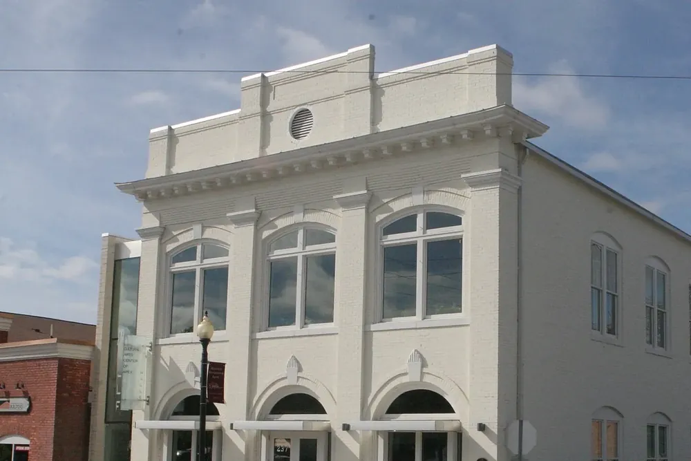 Historic white Apex Town Hall building with arched windows on Salem Street in Apex, North Carolina