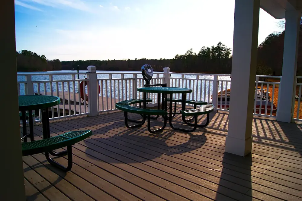 Lakeside deck with picnic tables overlooking Bass Lake in Holly Springs, North Carolina